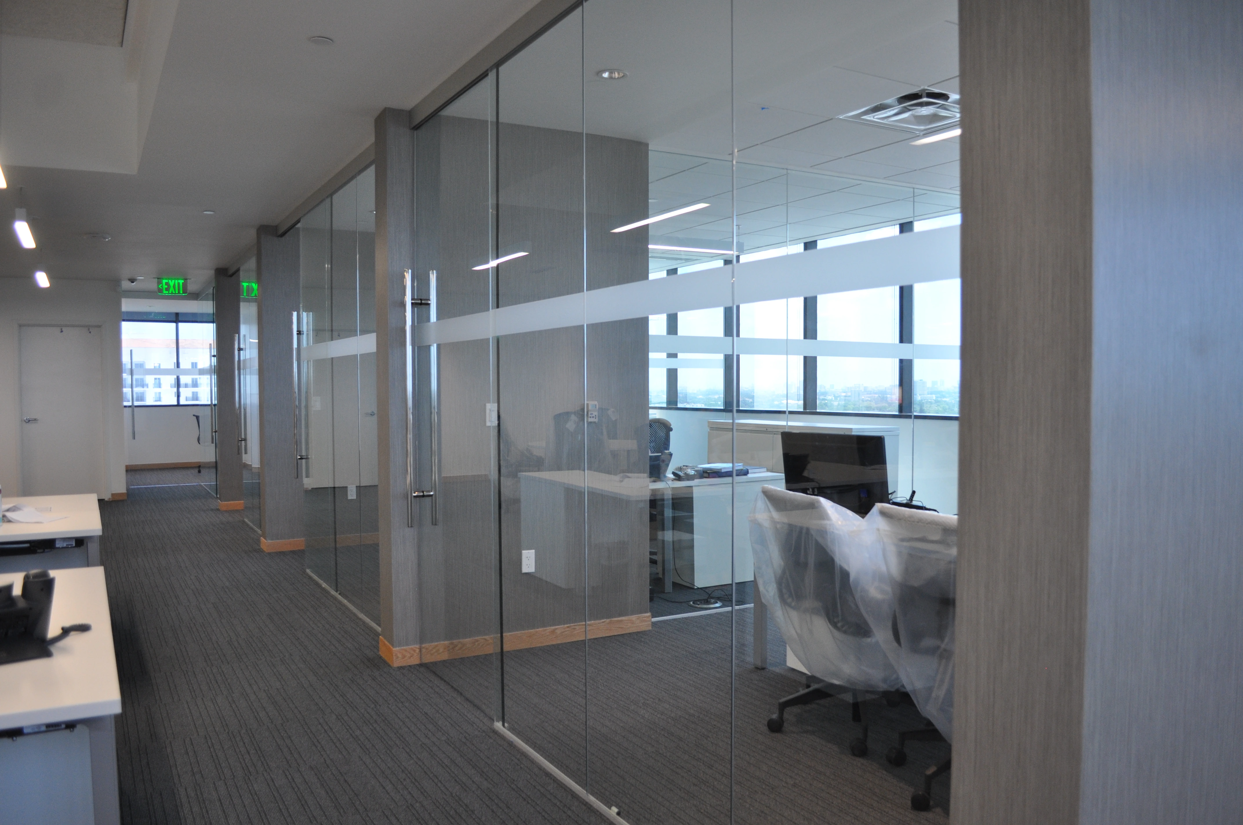 A modern office with all-glass fronts for private offices