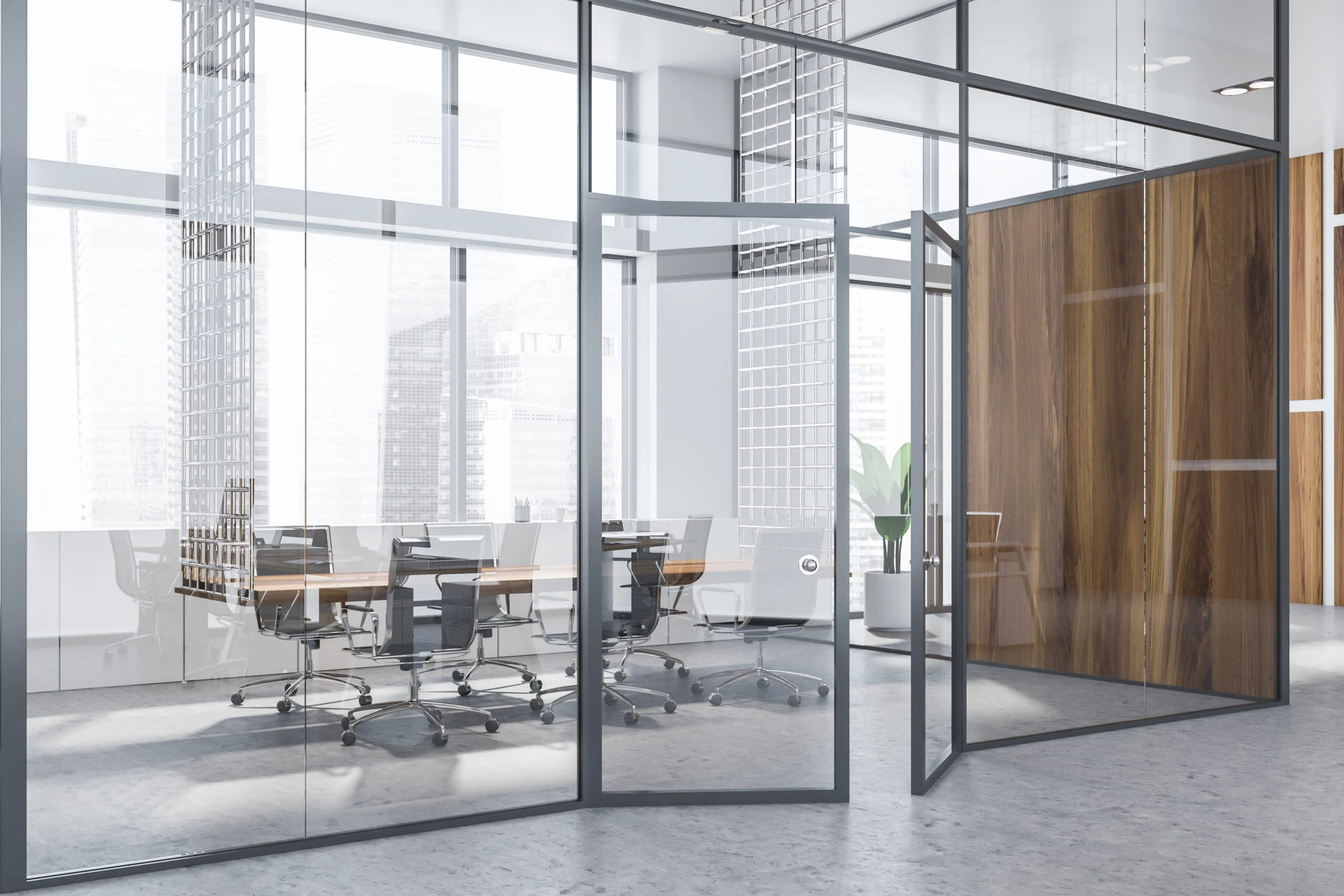 A bright, modern conference room enclosed by floor-to-ceiling glass walls