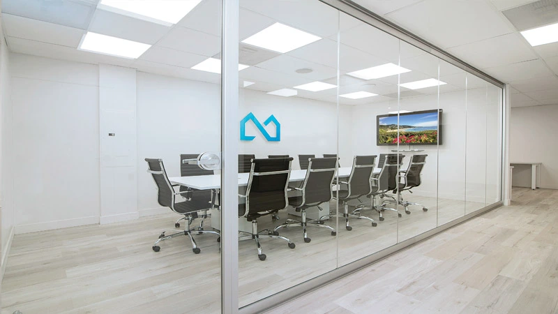 A certified fire-rated glass wall system in a commercial building corridor